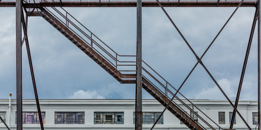 Steel stairway with handrails on an exterior steel frame